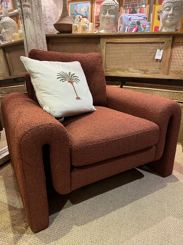 Burnt orange armchair in a soft boucle fabric